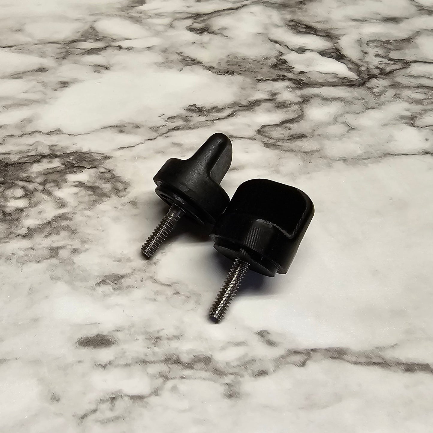 side view of the replacement knob next to the OEM knob