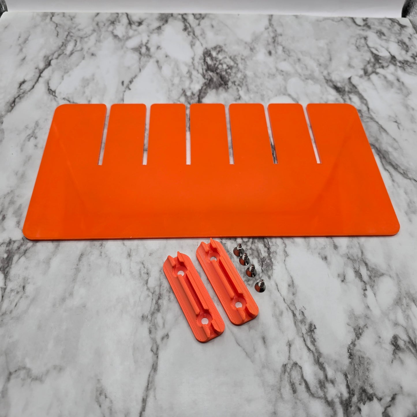 An image showing the YakAttack BlackPak Pro Divider System with orange and black dividers arranged within a black storage container to organize gear compartments.