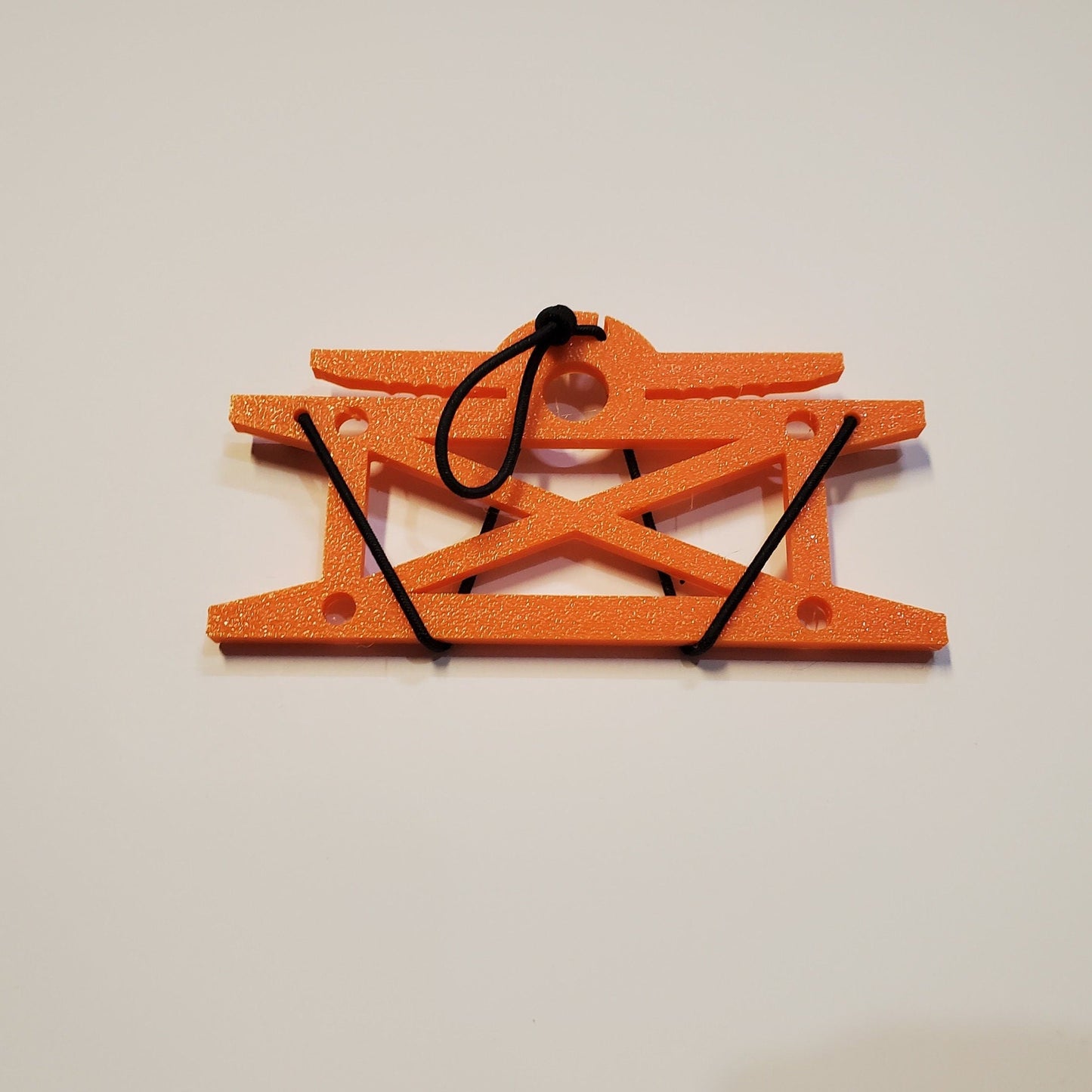 Image of a cord winder with included bungee