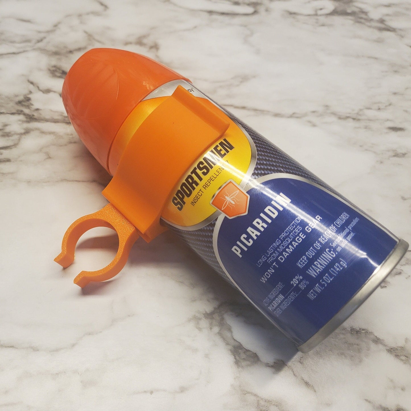 photo of bug spray being held with the clip rotated for a horizontal bar