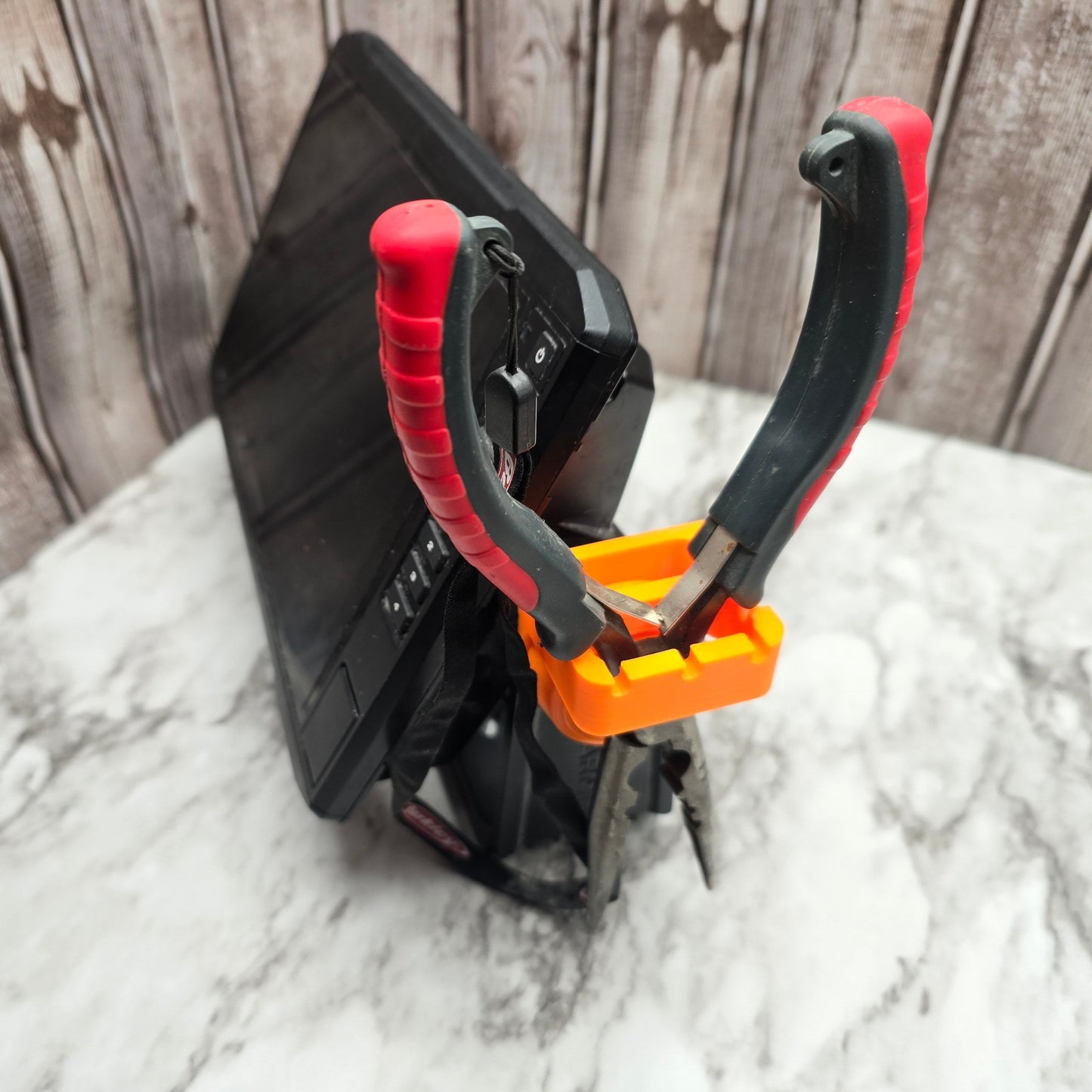 Side view of the chartplotter tool holder holding pliers