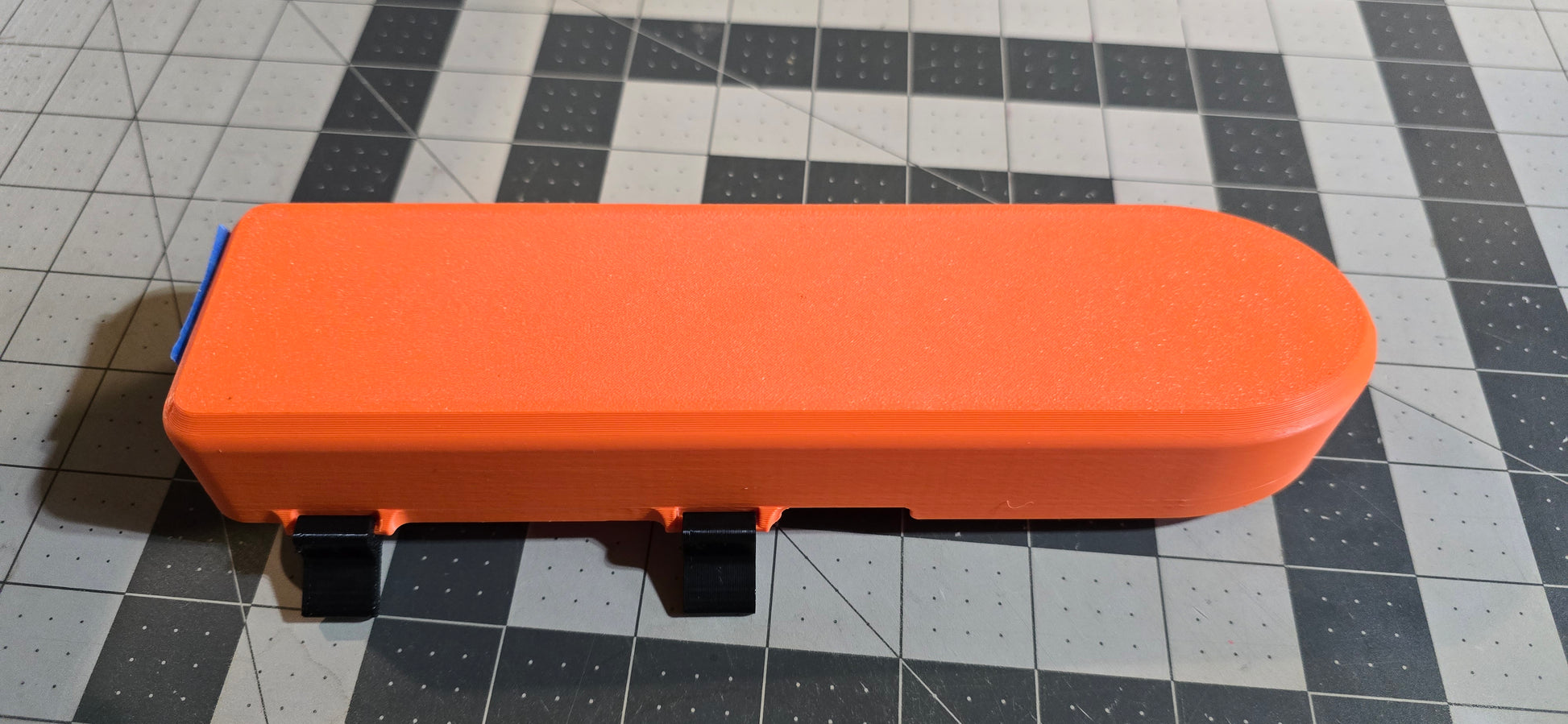 Orange and black transducer cover on a grid background