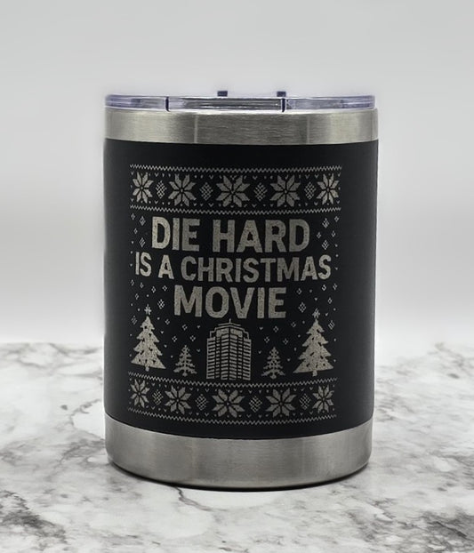 Tumbler with 'Die Hard is a Christmas Movie' text and festive design on a marble surface.