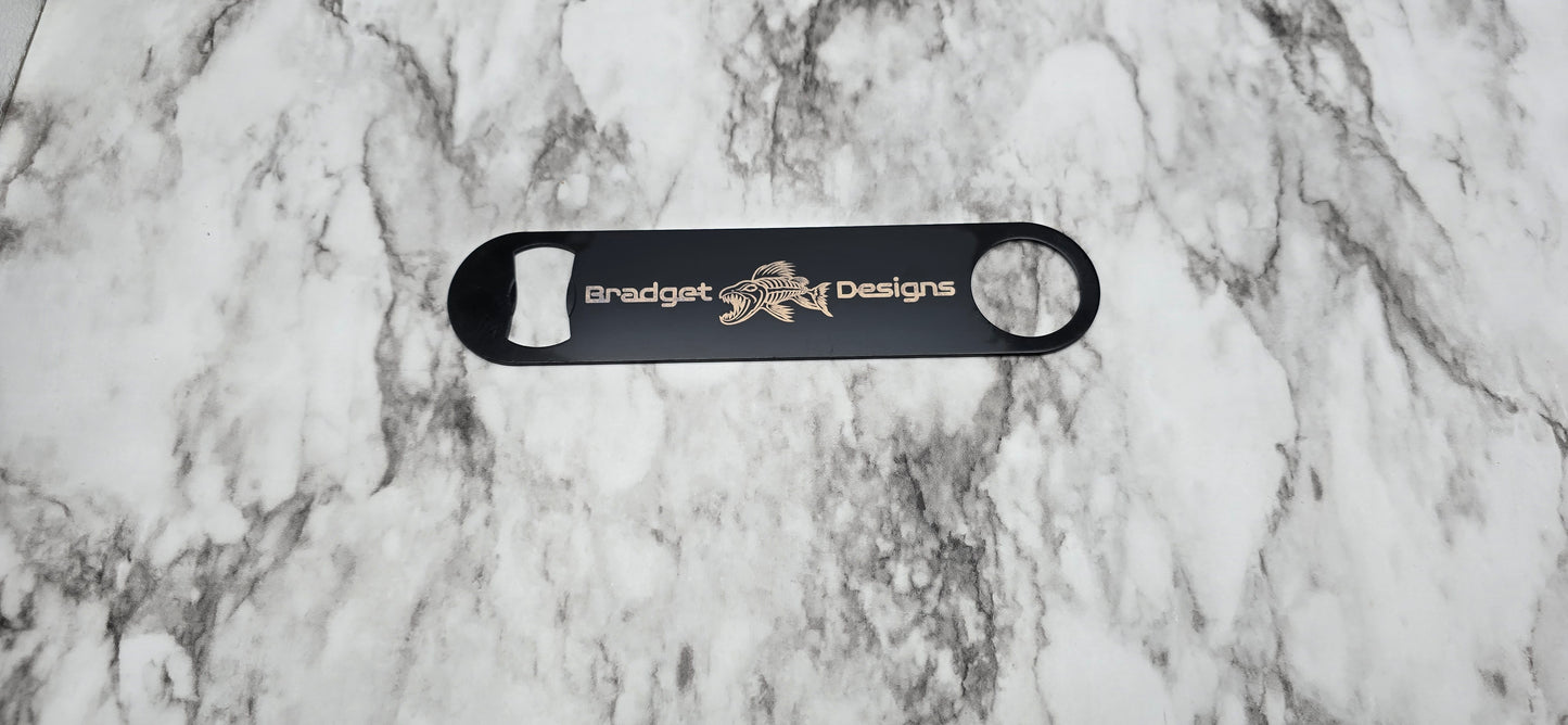 Black bottle opener with branding on a marble surface