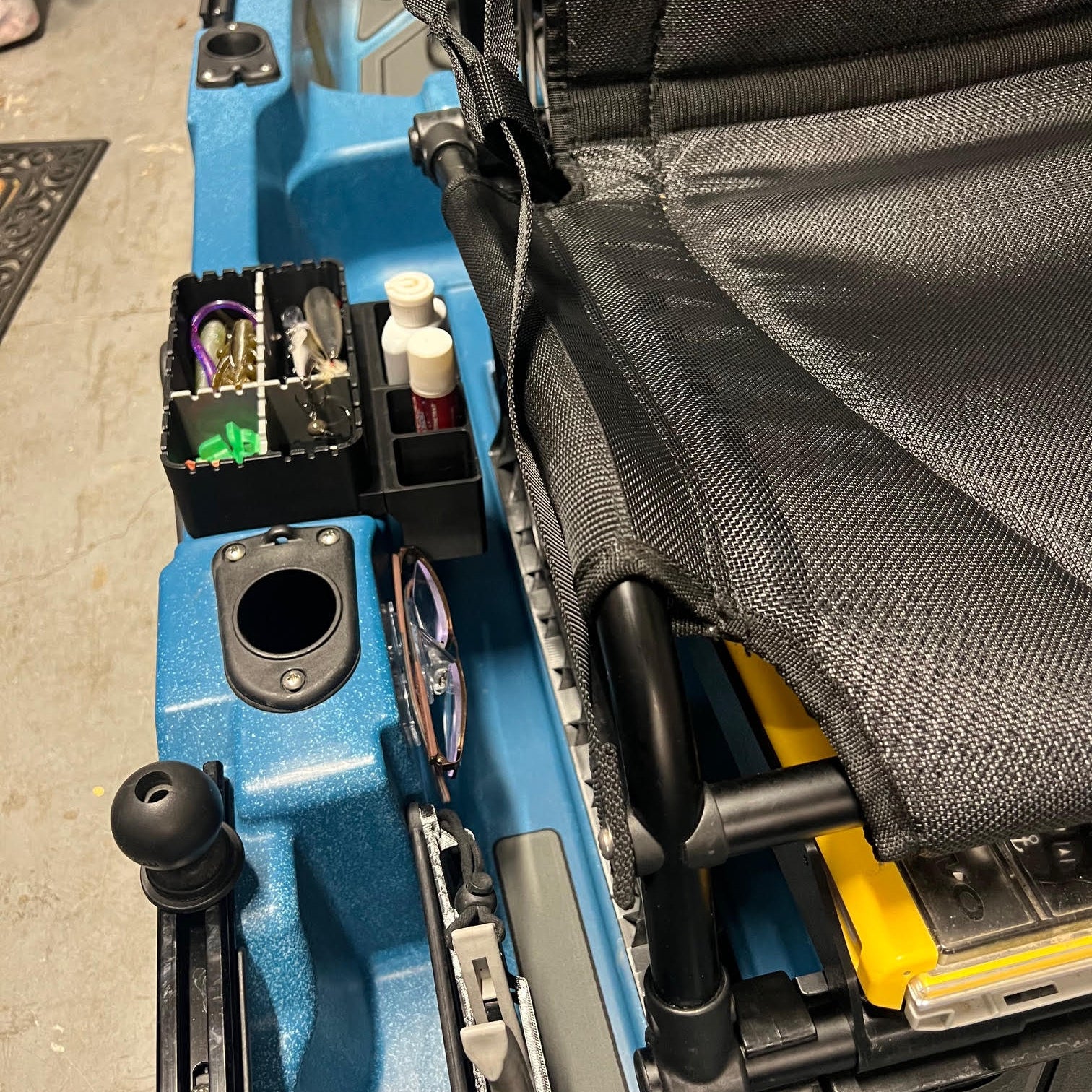 Tray with side pockets installed in kayak