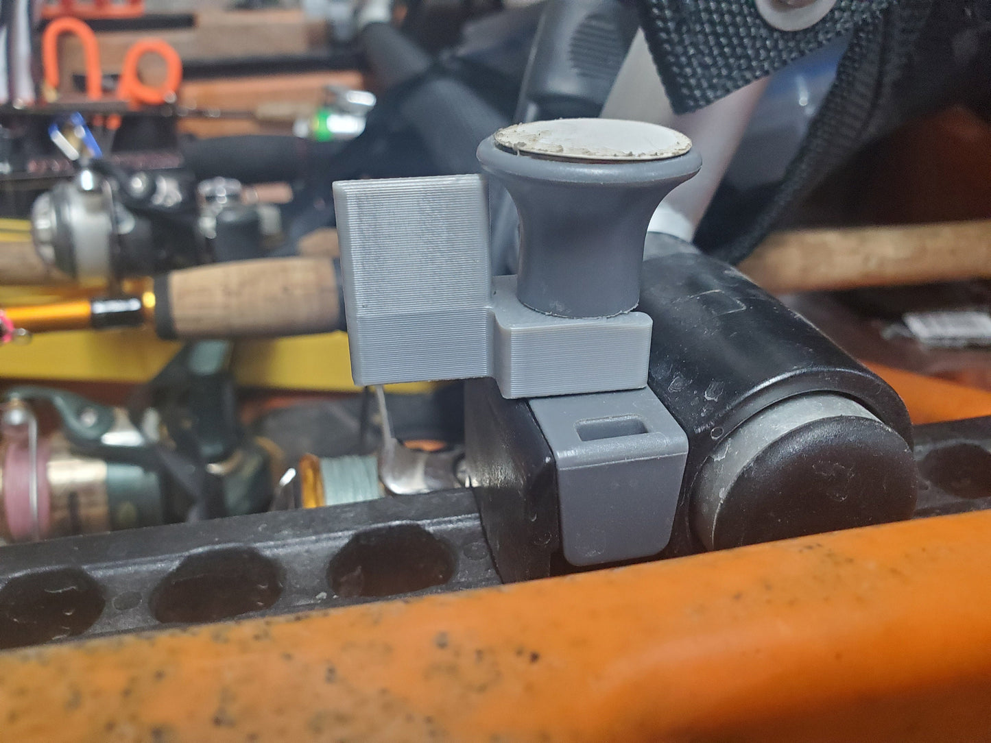 image of a gray seat plunger clip instsalled
