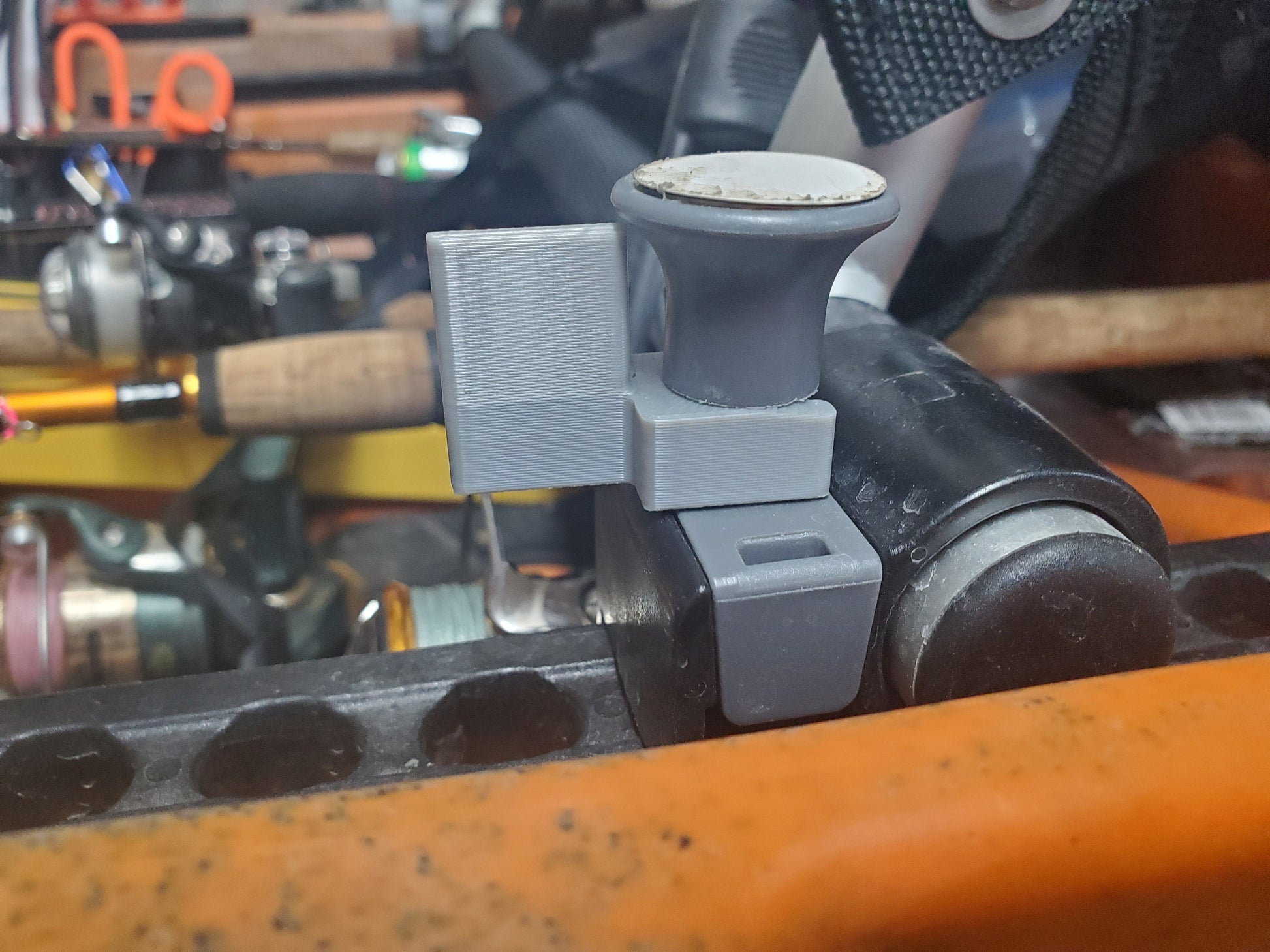 image of a gray seat plunger clip instsalled