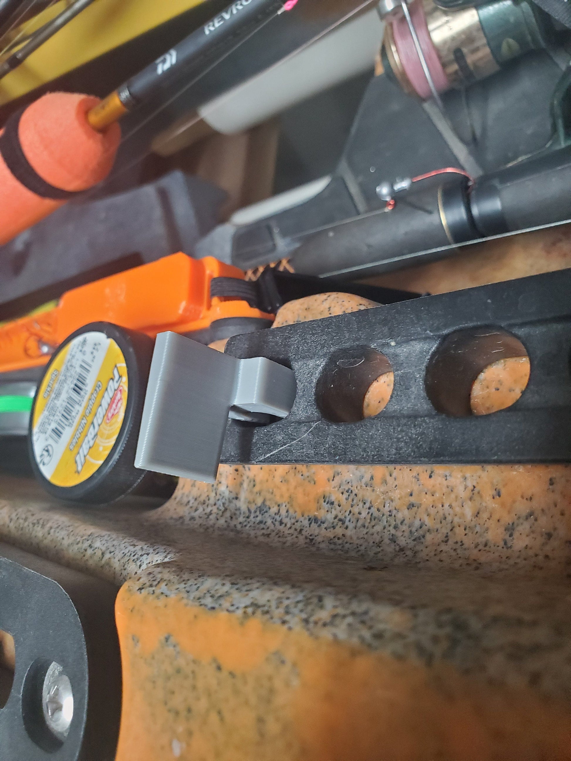 photo of the seat plunger clip stowed in  a hole on the seat rail